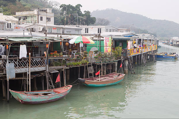 Hong Kong, China - February 12, 2012: People at Tai O Fishing Town, Lantau Island, Hong Kong. The houses at Tai O are built on river stilts and its lanes are filled with shops selling dried seafood. It is a tourist attraction in Hong Kong.
